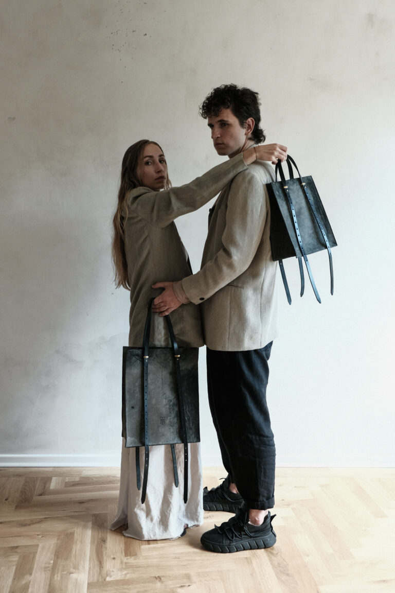 Two models carry the vibrant tote in sizes small and large in their hands